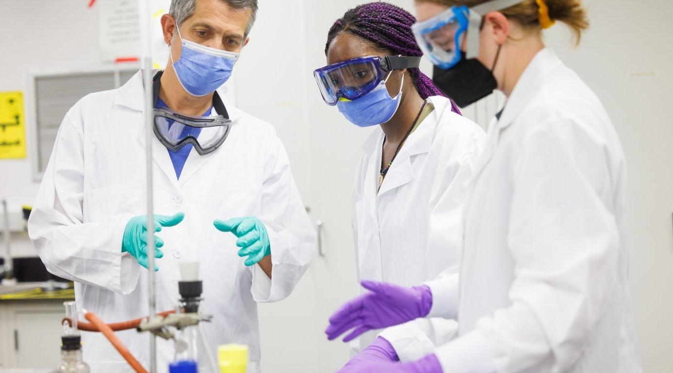 Students in a chemistry lab speak to their professor during a class at the Nucleus